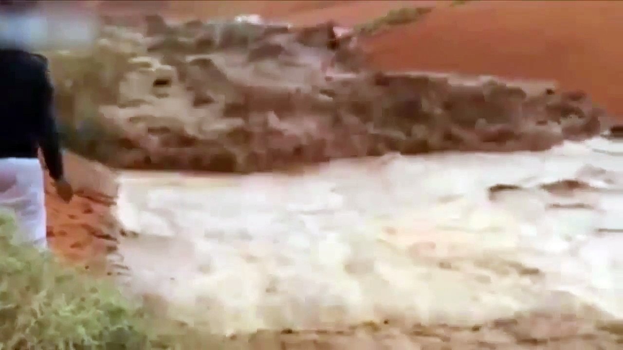4x4 is swept away after driver tries to cross raging floodwater in middle of DESERT