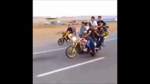 This might be the world record for most people on a motorcycle doing a wheelie