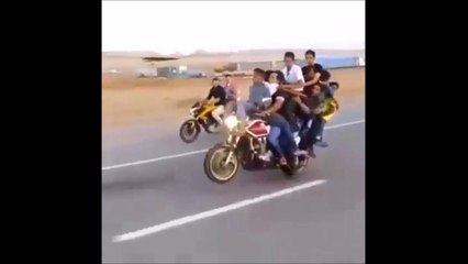 This might be the world record for most people on a motorcycle doing a wheelie