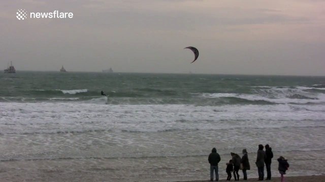 Windsurfers enjoy stormy UK coast