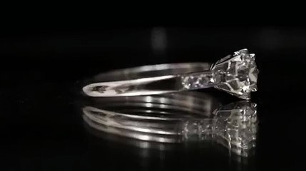 Flanked solitaire diamond engagement ring, circa 1920.