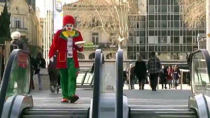 Clown rides an escalator