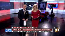 Truck plows into apartment building