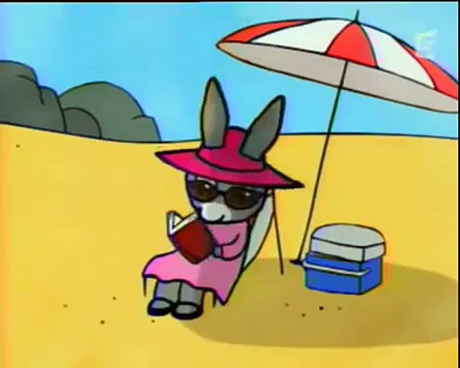 Dessin animé de L'âne Trotro Construit un Grand Château de Sable avec un drapeau mais