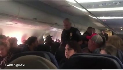 Unruly female passenger shouts as she is removed from plane
