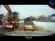 Excavator Truck driver helps stuck Truck to go with his "Arm"