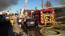 Crews battle 2 alarm warehouse fire in the Midway