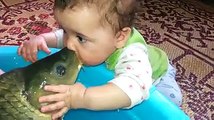 Little boy is kissing the fish - funny