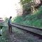boy performs stunt in front of train