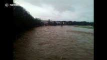 Debris floats along River Don in Scotland after it burst its banks following heavy rain