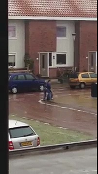 Guy cant put away his garbage because of the ice layered streets.