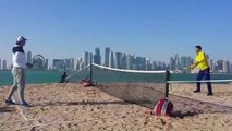 Rafael Nadal and Novak Djokovic play tennis on the beach in Doha.