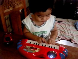 Baby Briam playing his new Christmas toy.