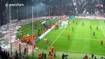 Violent clashes at Greek football match after mass pitch invasion