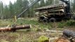 Valtra forestry tractor with big fully loaded trailer in wet forest