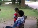 Son is massaging his father's head inside the park at daylight