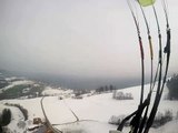 Paragliding over snow-capped fields
