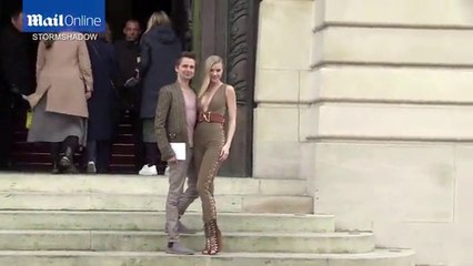 Matt Bellamy and Elle Evans cuddle up at Balmain PFW show