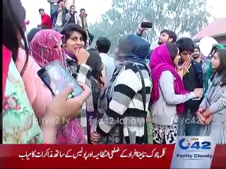 Students dancing on canal road in traffic jam