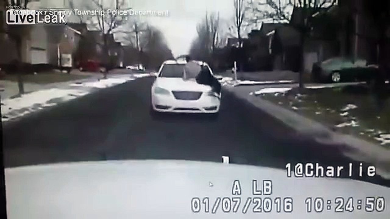 Man desperately hangs to car during fight with...