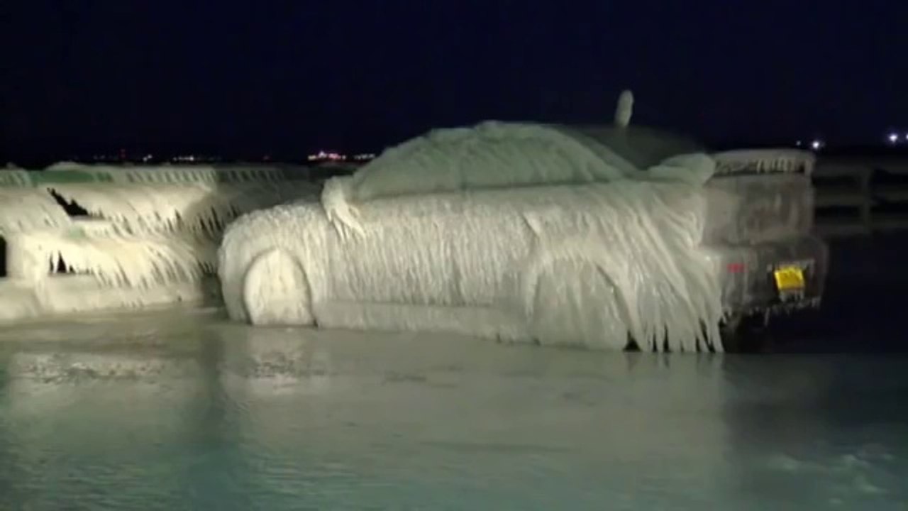 Car entirely covered with Ice while parked near by Lake during Snow Storm