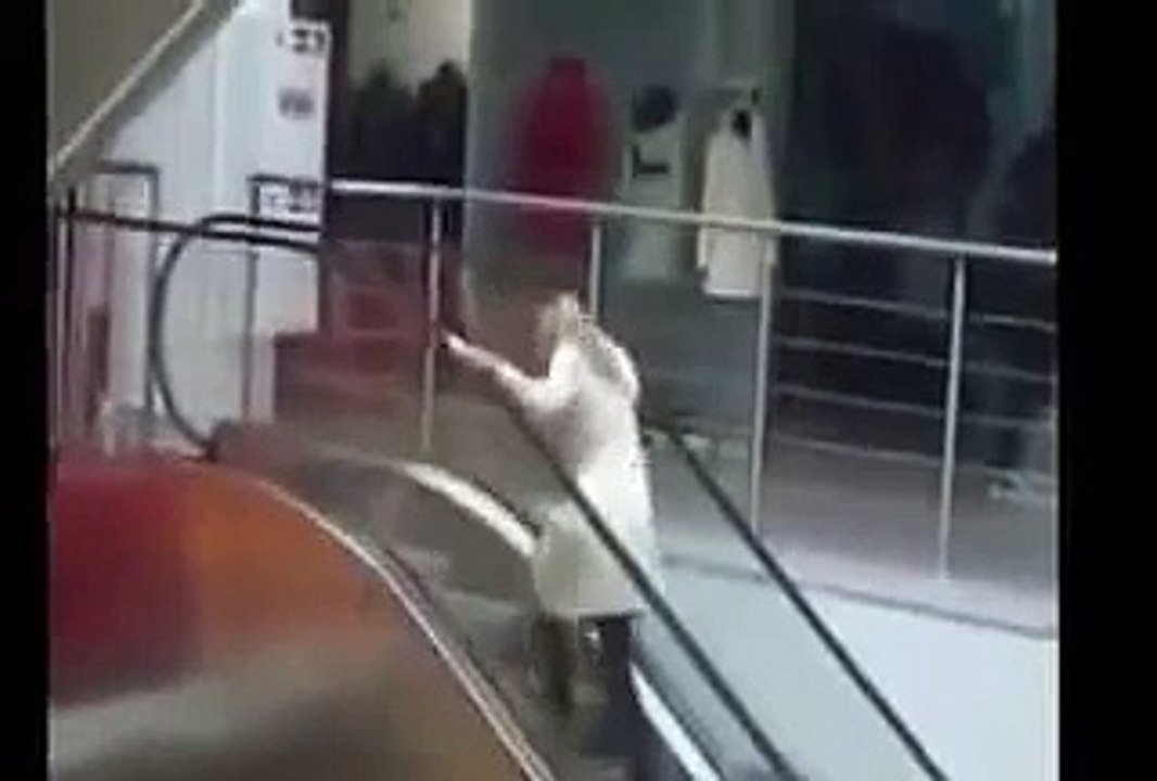 A lady who climbs the escalator in reverse ..!
