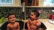 Twin babies in sink fun laugh at mom