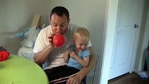 Cute Baby Laughing Hysterically At Deflating Balloons With His Dad