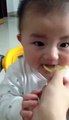 A Baby's funny face after eating Lemon