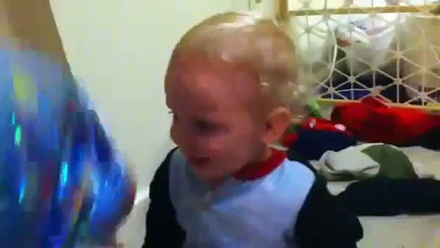 Cute Baby Laughing At And Playing With A Balloon