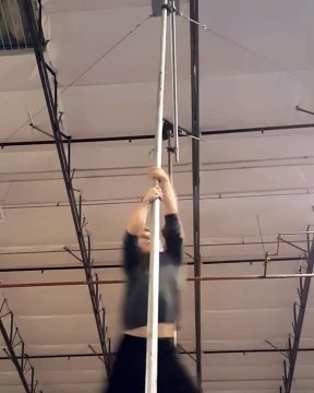 Dancer Climbs Up Pole then Spins Back Down