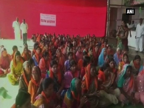Local women gather outside Shani Shingnapur to bar women activists