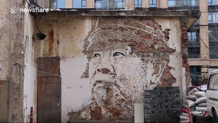 Chinese artist carves vivid image of a face on an old wall
