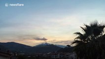 Black smoke spews out of Mount Etna volcano as sun sets