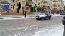 Slip sliding away: cars and buses negotiate ice covered road in Azerbaijan