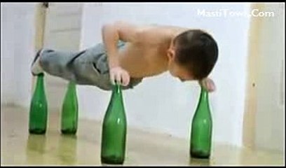 Small Boy Doing Push Ups on beer bottles
