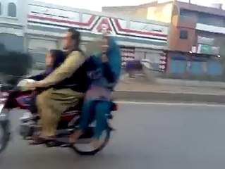 Boy wheeling on Bike with his Girl Friend Kirancollections