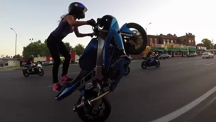 Crazy girl does motorcycle stunts on St