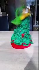 parrot  playing with Christmas toy tree