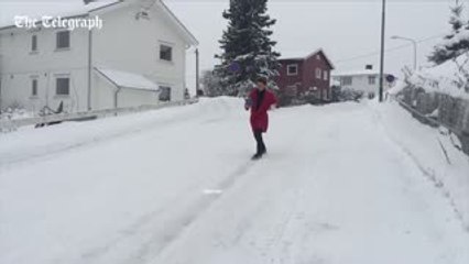 Norwegian man slides down hill in slow-motion with coffee