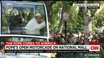 Pope Francis kisses children during parade