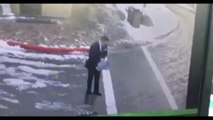 Man pours salt on icy road