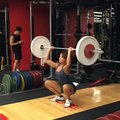 Girl Lifts Heavy Weights over Head