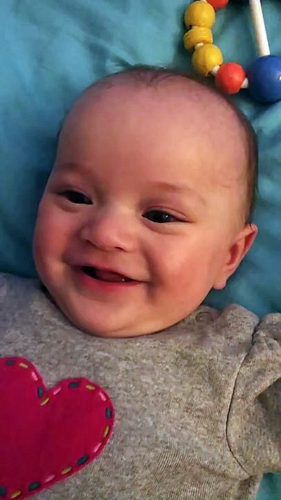 Funny cute baby laughing at kisses from mommy 4 month old