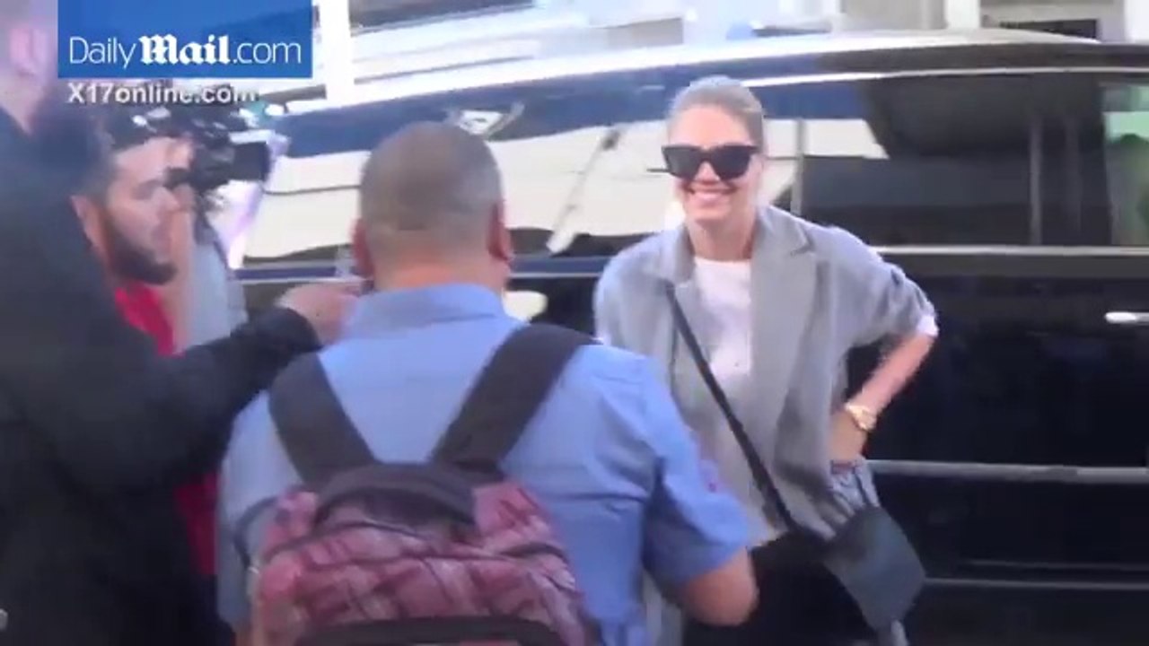 Kate Upton jets out of LAX in long coat and distressed jeans