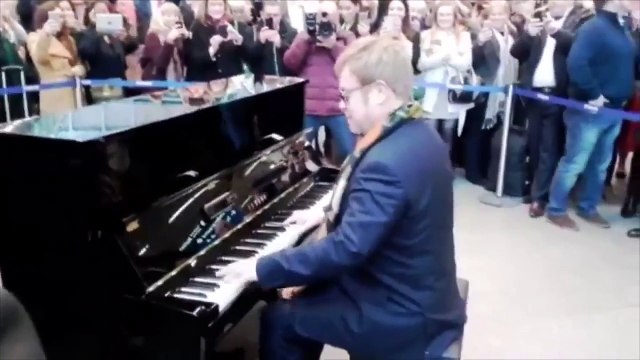 Elton John plays the piano at St.Pancras to a delighted crowd