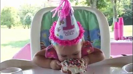 1-year-old birthday girl figures out how to eat cake. We like her methods!