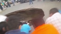 Pedestrians Rescue Family After Car Swallowed by Giant Sinkhole