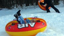 Kids Having Fun Snow Tubing In The Same Yard They Go Water Sliding In The Summer