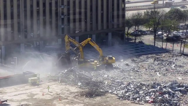 Parking Garage Demolition gone wrong falling on Backhoe Truck